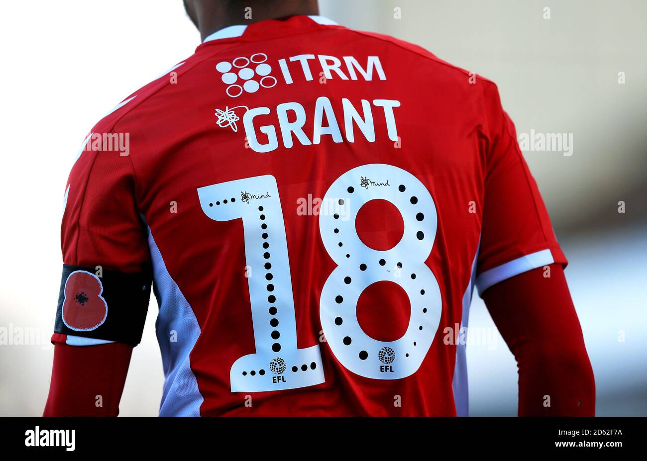 Close up of Charlton Athletic's Karlan Ahearne-Grant shirt with Mind Charity branding and poppy appeal arm band Stock Photo