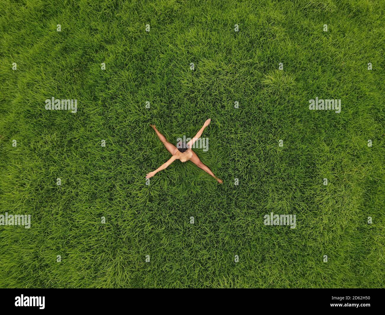 Human cross concept created viewing a nude women from above. Stock Photo