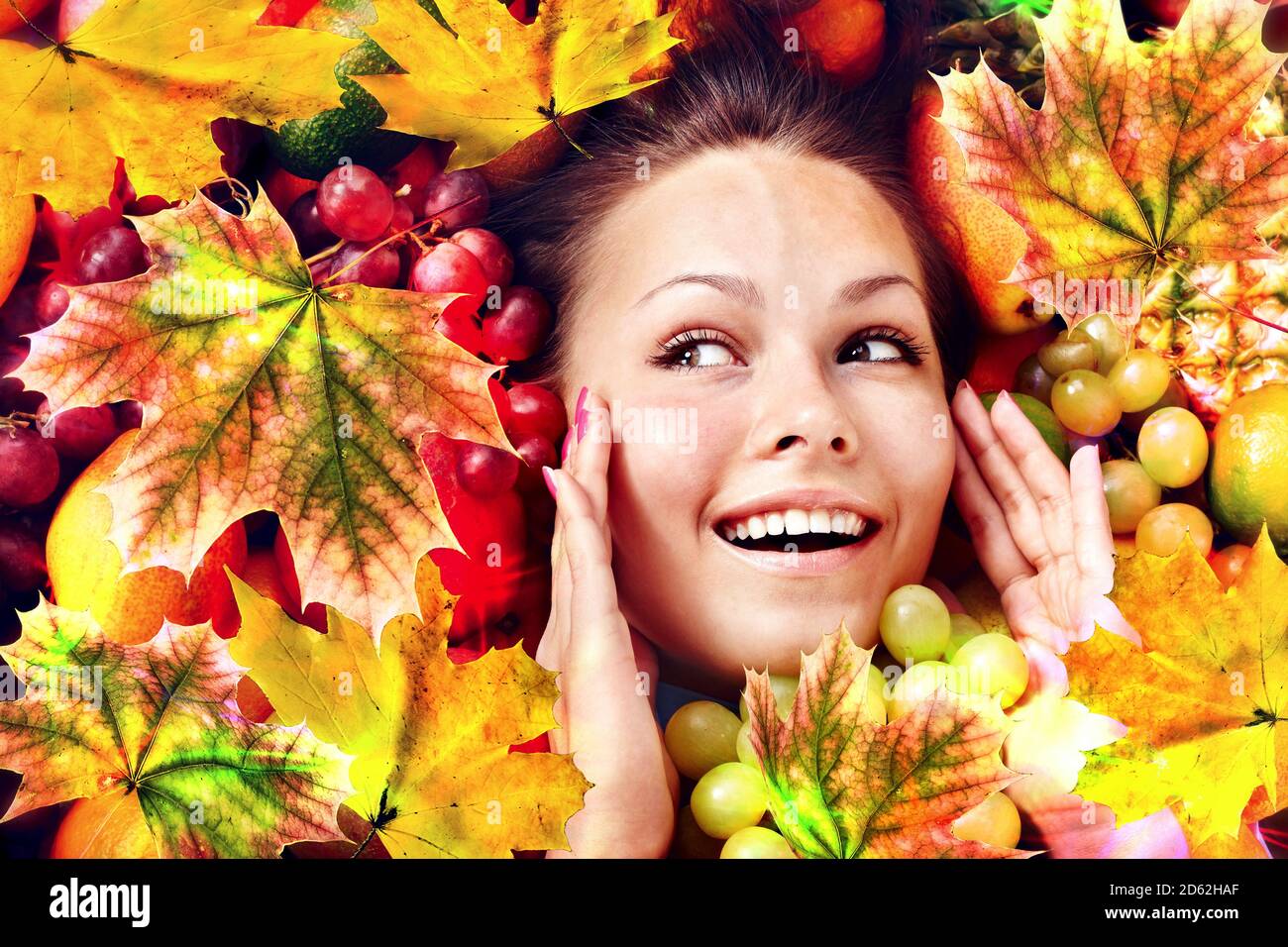 Autumn leaves background with face and hands woman Stock Photo