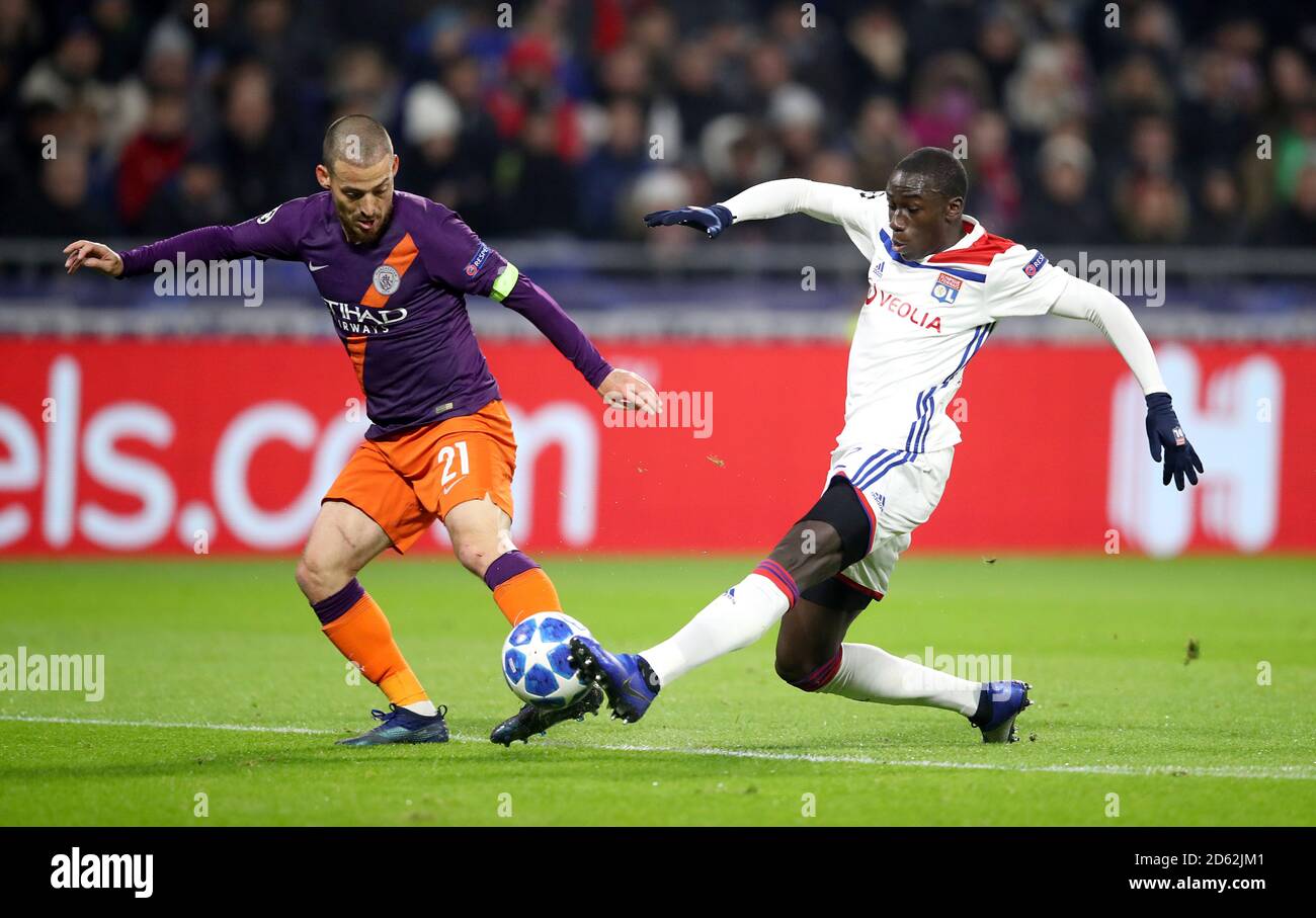 Manchester City's David Silva (left) and Lyon's Ferland Mendy battle