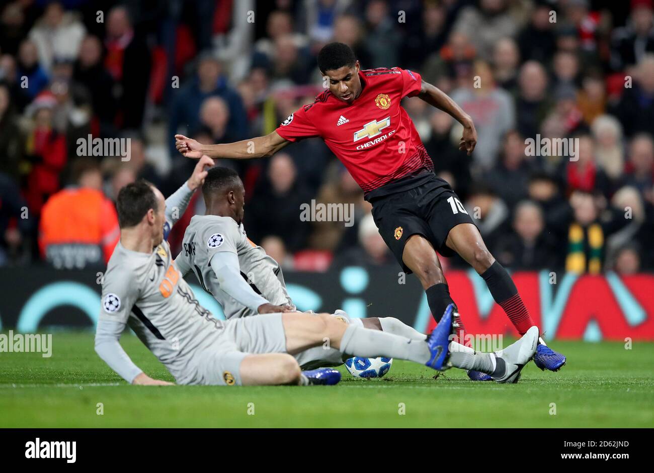 BSC Young Boys' Mohamed Ali Camara (centre) and BSC Young Boys' Steve von Bergen (left) slide in on Manchester United's Marcus Rashford Stock Photo