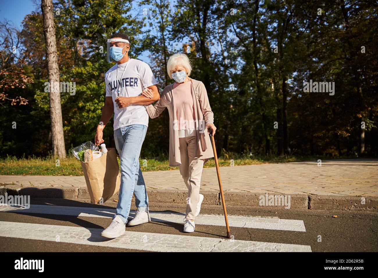 Old woman walking stick crossing hi-res stock photography and images ...