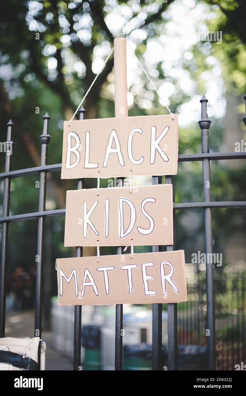 Black Kids Matter Sign Hanging on Metal Fence, New York City, New York, USA Stock Photo