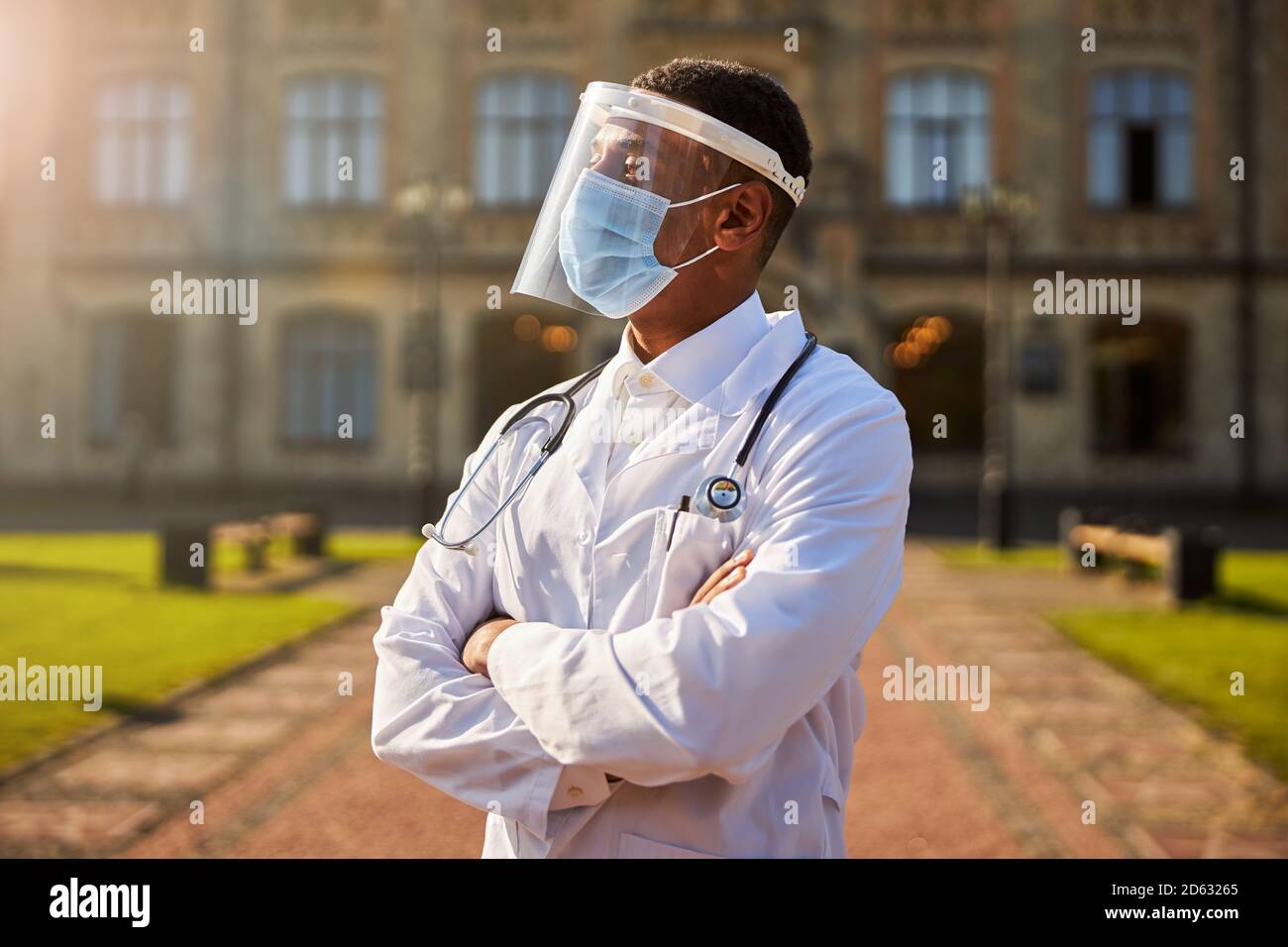 Thoughtful male physician looking in the distance Stock Photo