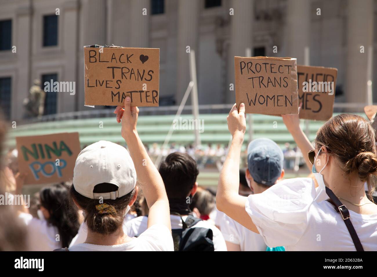 Protesters holding up Black Trans Lives Matter and Protect Trans Women Signs during Protest outside Brooklyn Museum, Brooklyn, New York, USA Stock Photo