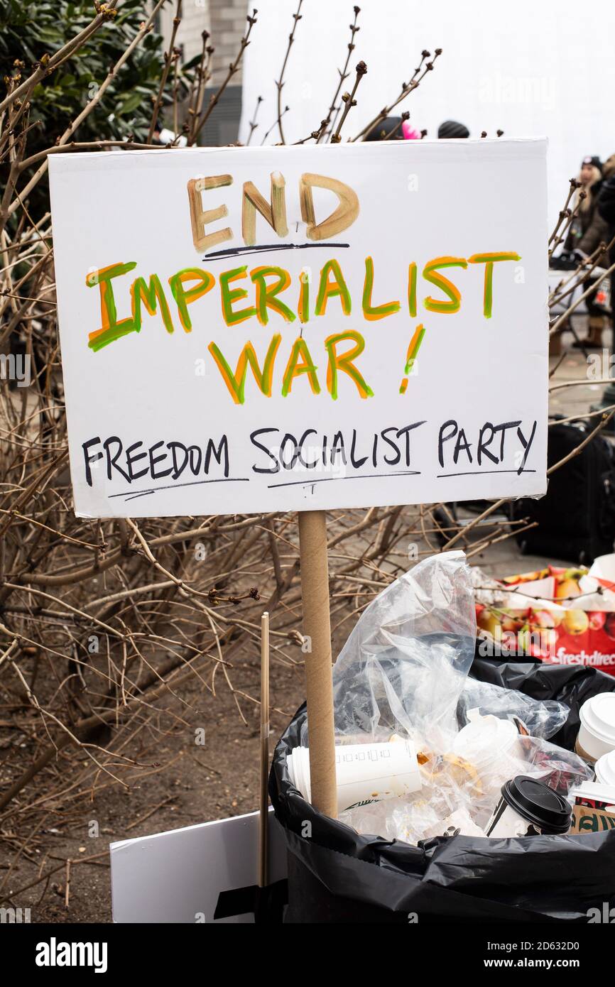 Protest Sign, 'End Imperialist War!', in Trash Can, Women's Unity March and Rally, Foley Square, New York City, New York, USA Stock Photo