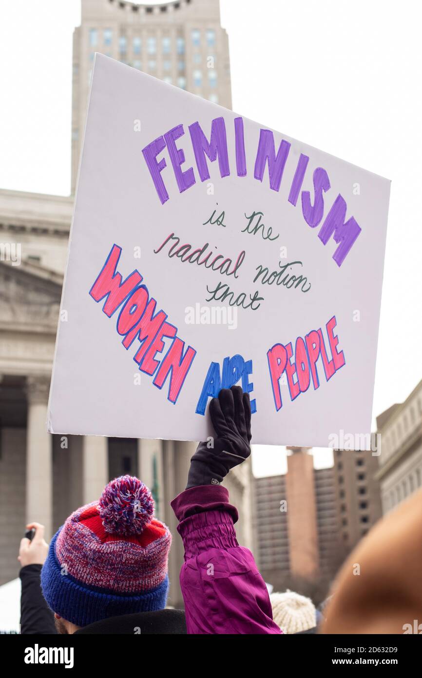 Woman holding Sign, 'Feminism is the Radical Notion', Women's Unity March and Rally, Foley Square, New York City, New York, USA Stock Photo