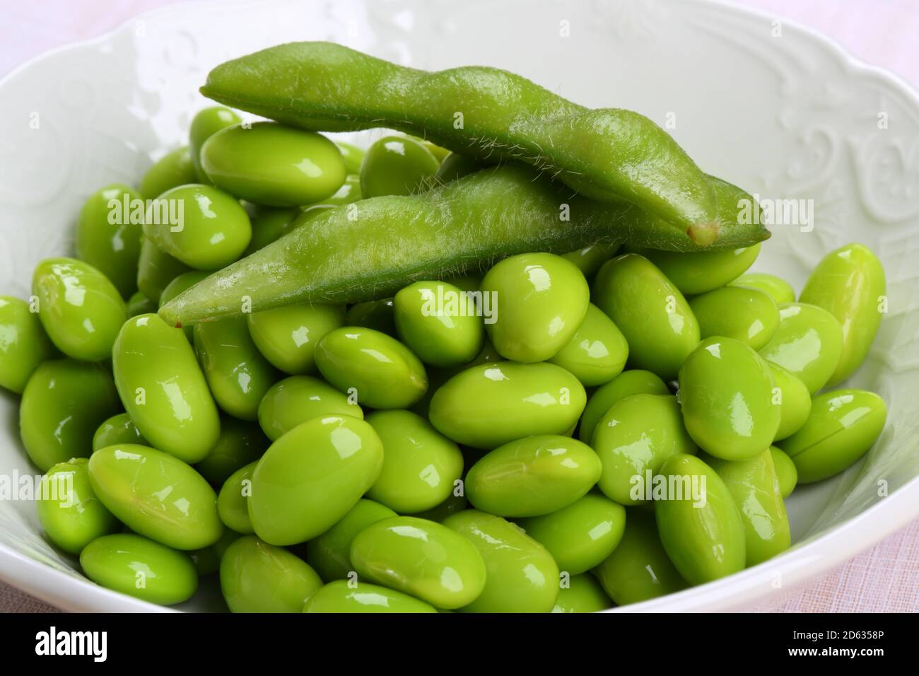 Fresh Green Peas in a White Bowl Stock Photo