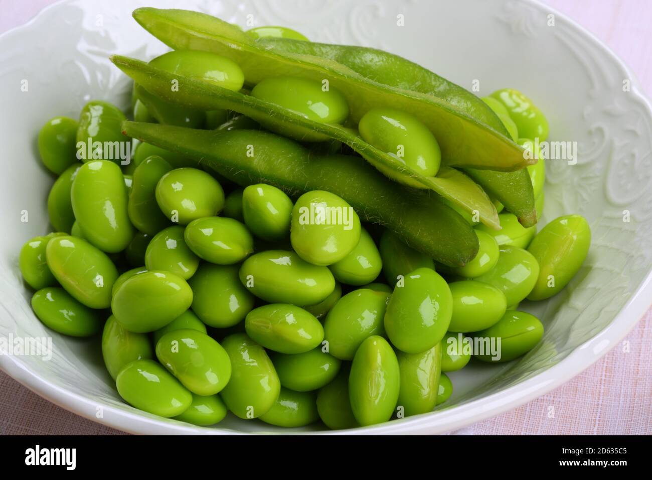 Fresh Green Peas in a White Bowl Stock Photo