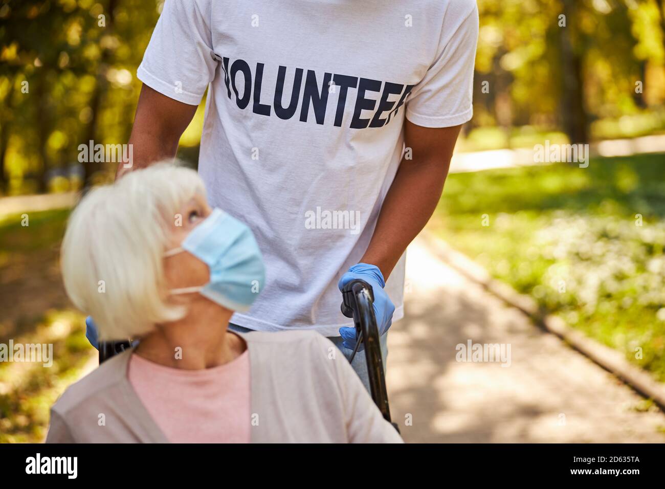 Lightly dressed volunteer aiding an elderly patient Stock Photo Alamy