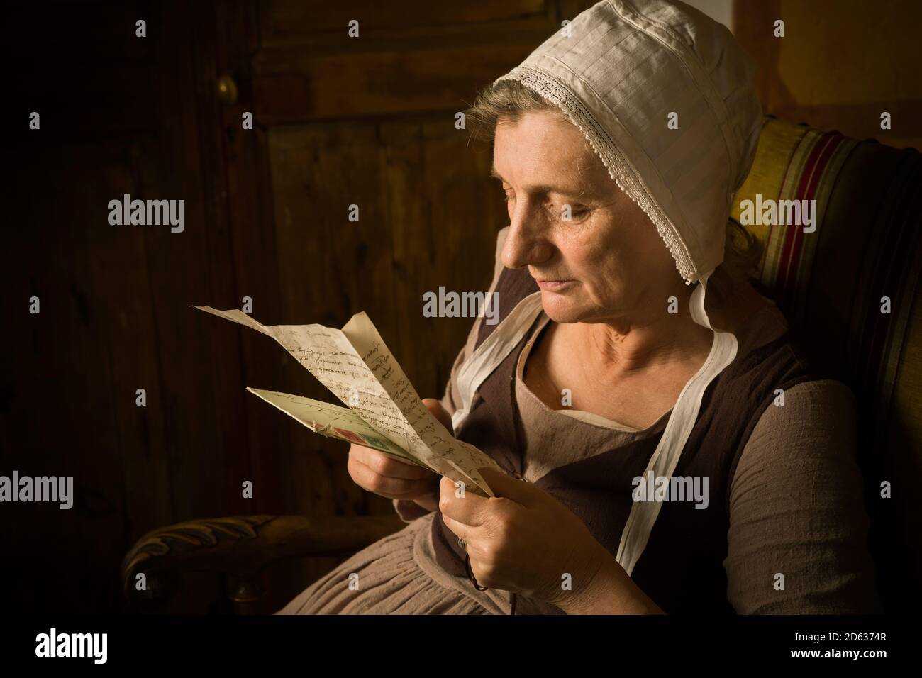 Portrait of a ature woman reading in an Old Master or Renaissance style Stock Photo