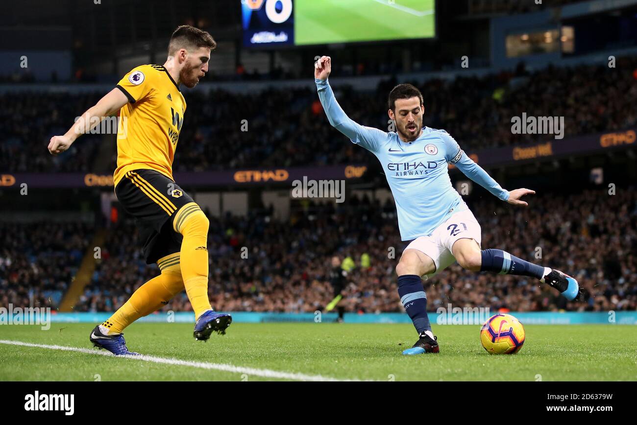 Wolverhampton Wanderers' Matt Doherty (left) and Manchester City's David Silva (right) battle for the ball Stock Photo