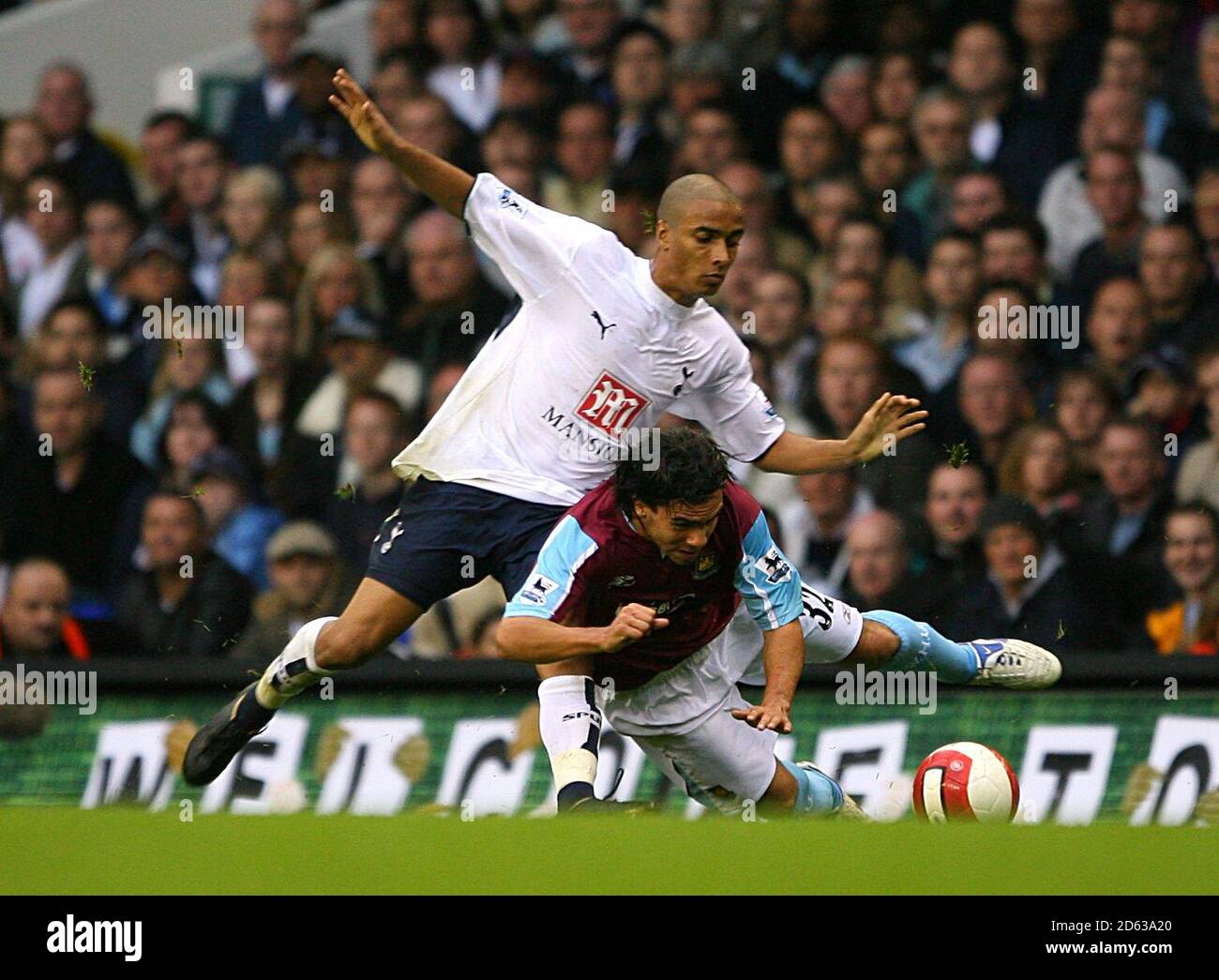 Tottenham Hotspur's Benoit Assou-Ekotto fouls West Ham United's Carlos Tevez Stock Photo