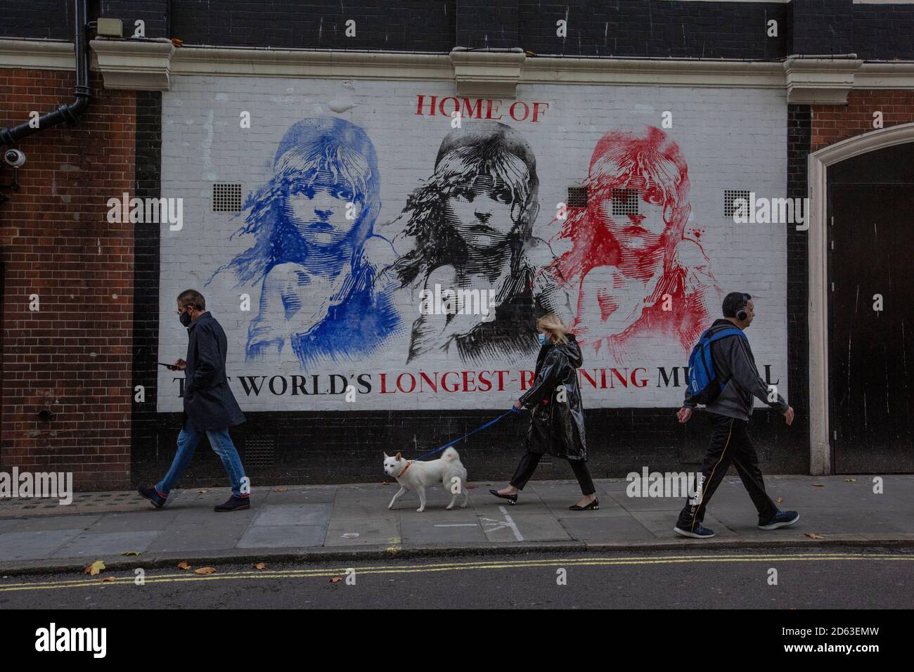 People walk past the Les Miserables theatre the longest-running musical in  the West End which is under threat due to the coronavirus lockdown measures  Stock Photo - Alamy