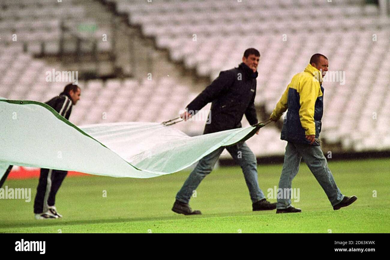 The ground staff bring out the covers on the first day of Cricket at ...