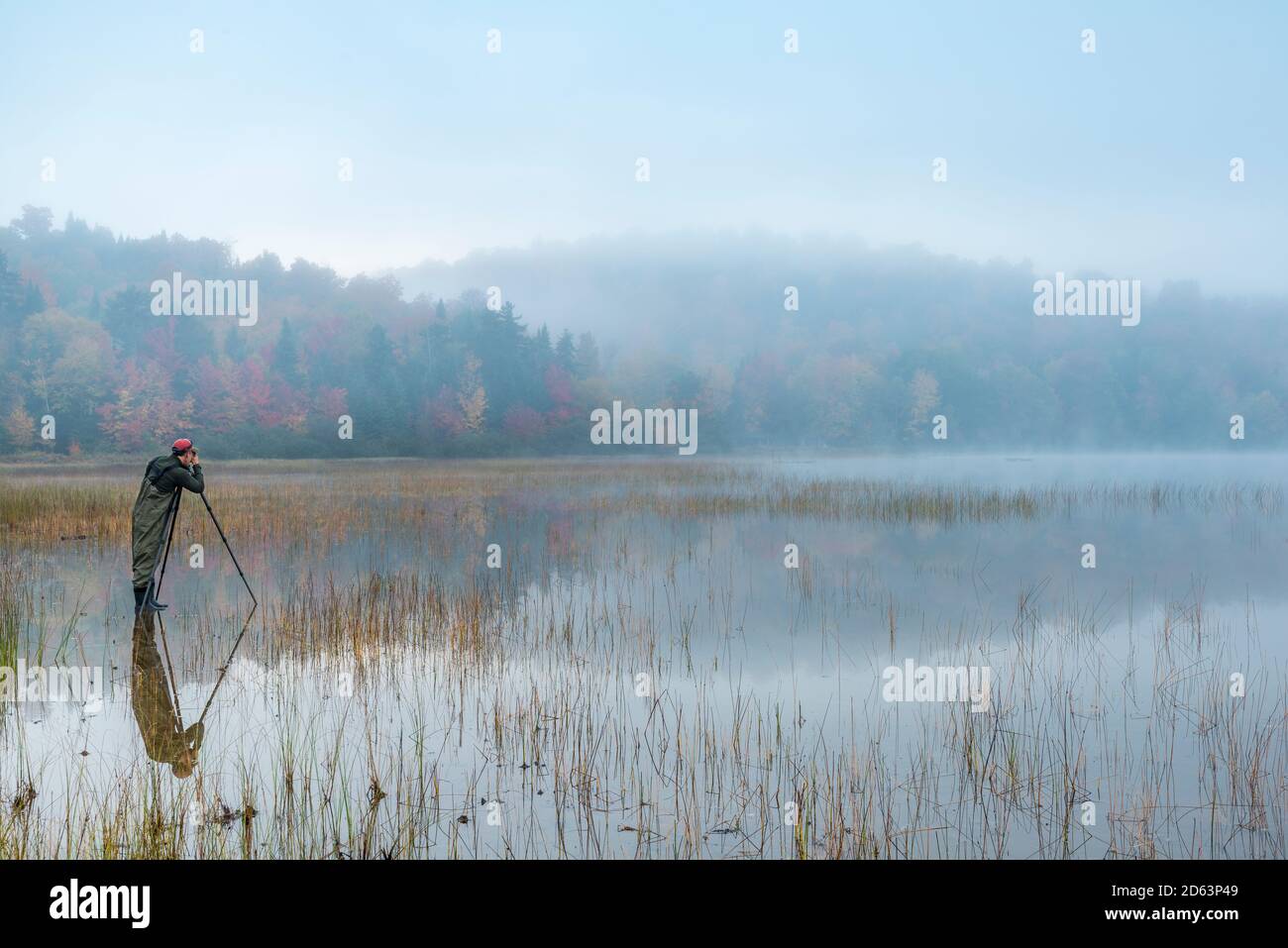 A photographer on a misty mountain lake, Adirondack Mountains, Essex County, Lake Placid, New York Stock Photo