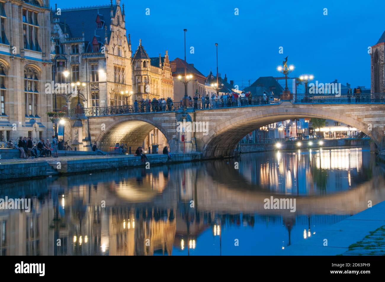 Ghent, Belgium, April, 2012. Graslei quay in historic city center of Ghent, Belgium. St Michael's Bridge and cityscape at night. Stock Photo