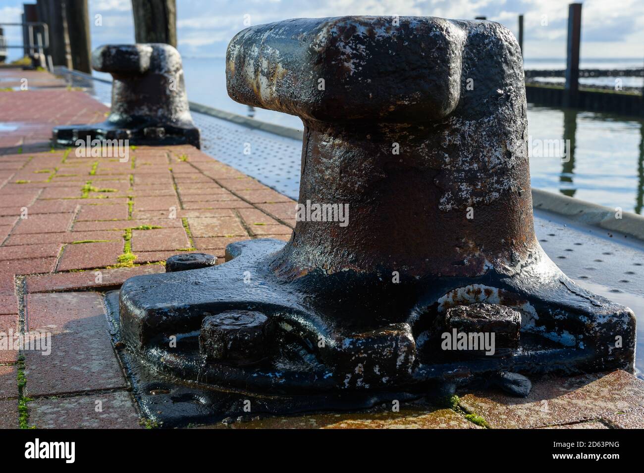 Wittduen, Schleswig-Holstein, North Friesland, Germany: rusty bollard at the ferry port of Wittduen on Amrum in the north sea Stock Photo
