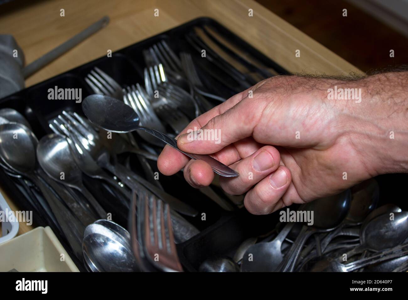 Putting Clean Dishes and Cutlery in Drawer Stock Photo Alamy