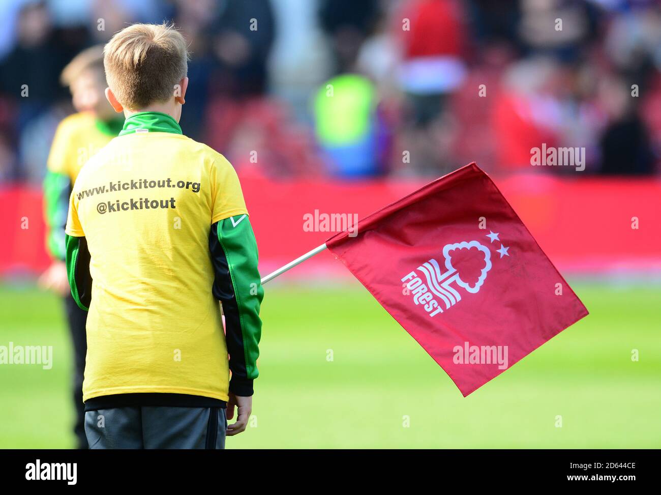 A child wearing a Kick It Out anti-rascism t-shirt holding a Nottingham Forest flag Stock Photo