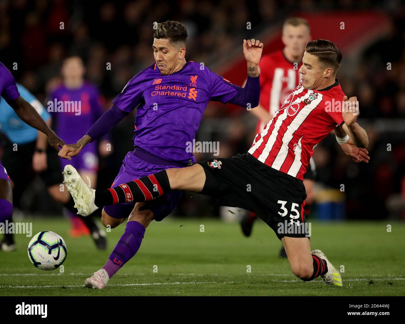 Liverpool's Roberto Firmino (left) and Southampton's Jan Bednarek battle for the ball Stock Photo