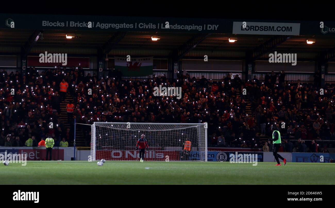 Charlton Athletic fans using their mobile phones torches at half time for mental heath awareness  Stock Photo