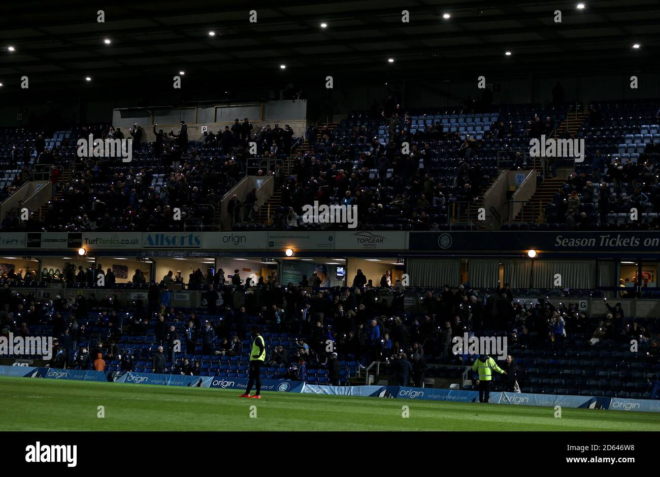 Wycombe Wanderers fans using their mobile phones torches at half time for mental heath awareness  Stock Photo