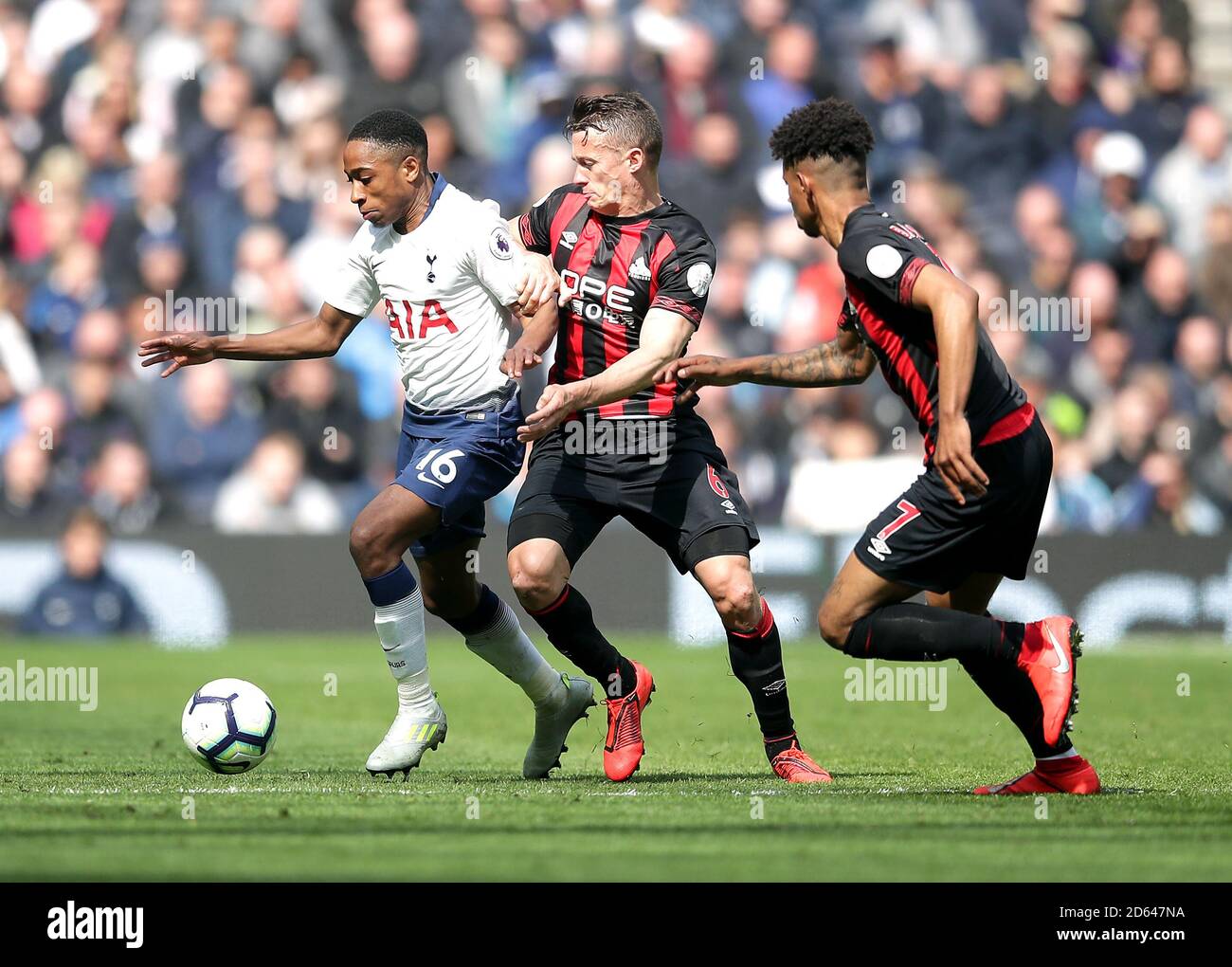 Tottenham Hotspur's Kyle Walker-Peters (left) battles for the ball with Bournemouth's Andrew Surman and Marc Pugh (right) Stock Photo