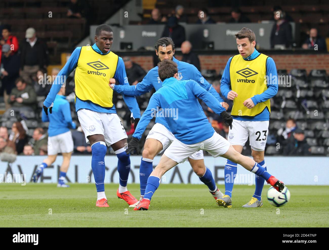Everton players warm up on the pitch ahead of the game Stock Photo