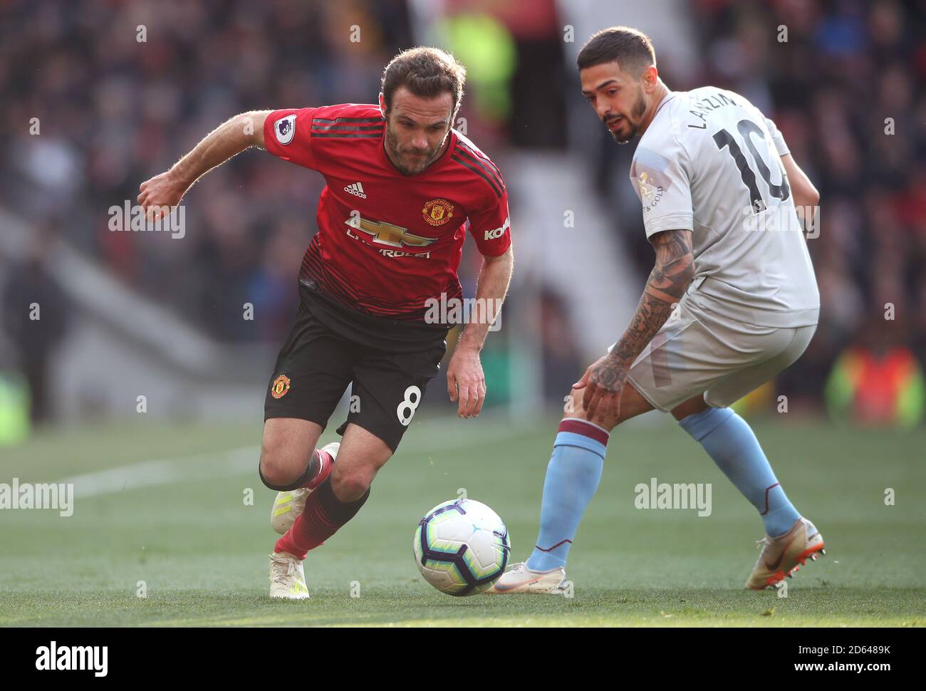 Manchester United's Juan Mata (left) and West Ham United's Manuel Lanzini battle for the ball Stock Photo