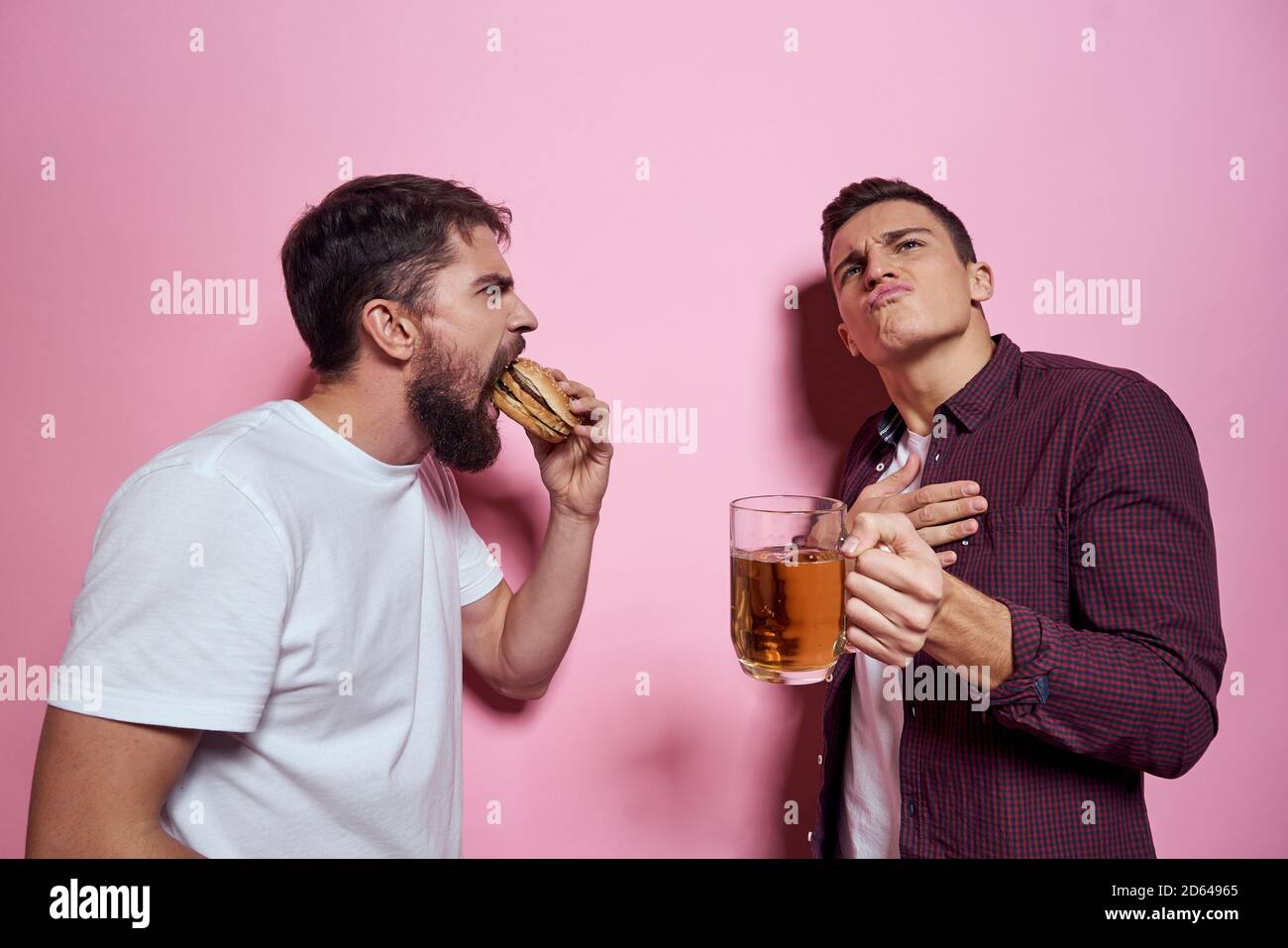 Two men drink beer friendship drunk alcohol lifestyle pink background Stock Photo Alamy