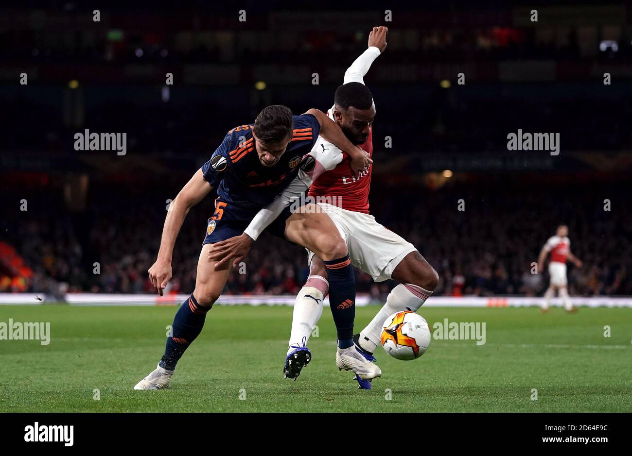 Valenciaâ€™s Gabriel Paulista (left) and Arsenal's Alexandre Lacazette battle for the ball Stock Photo