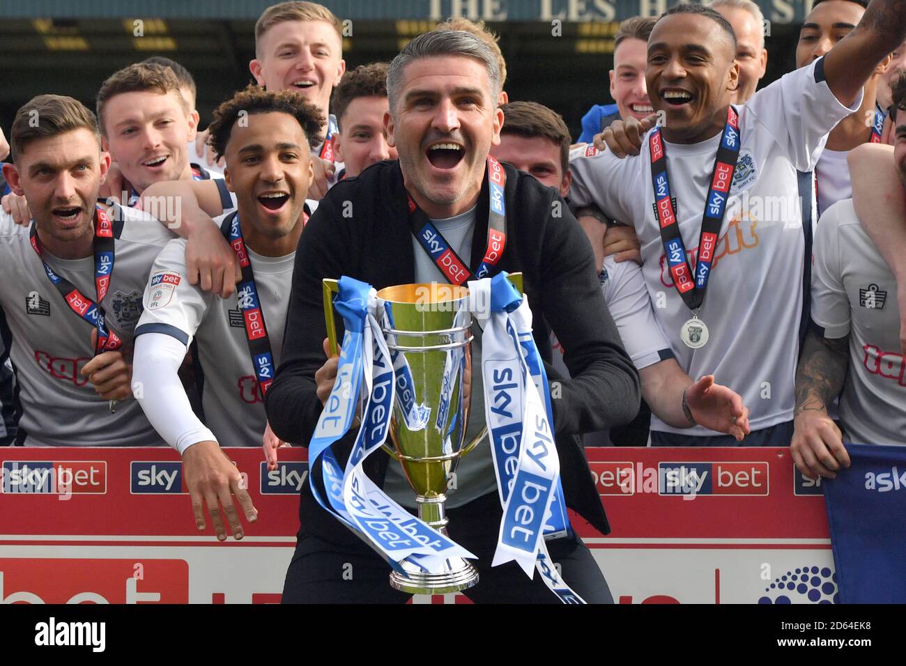 Bury’s manager Ryan Lowe lifts the trophy during a lap of honour as Bury are promoted  Stock Photo