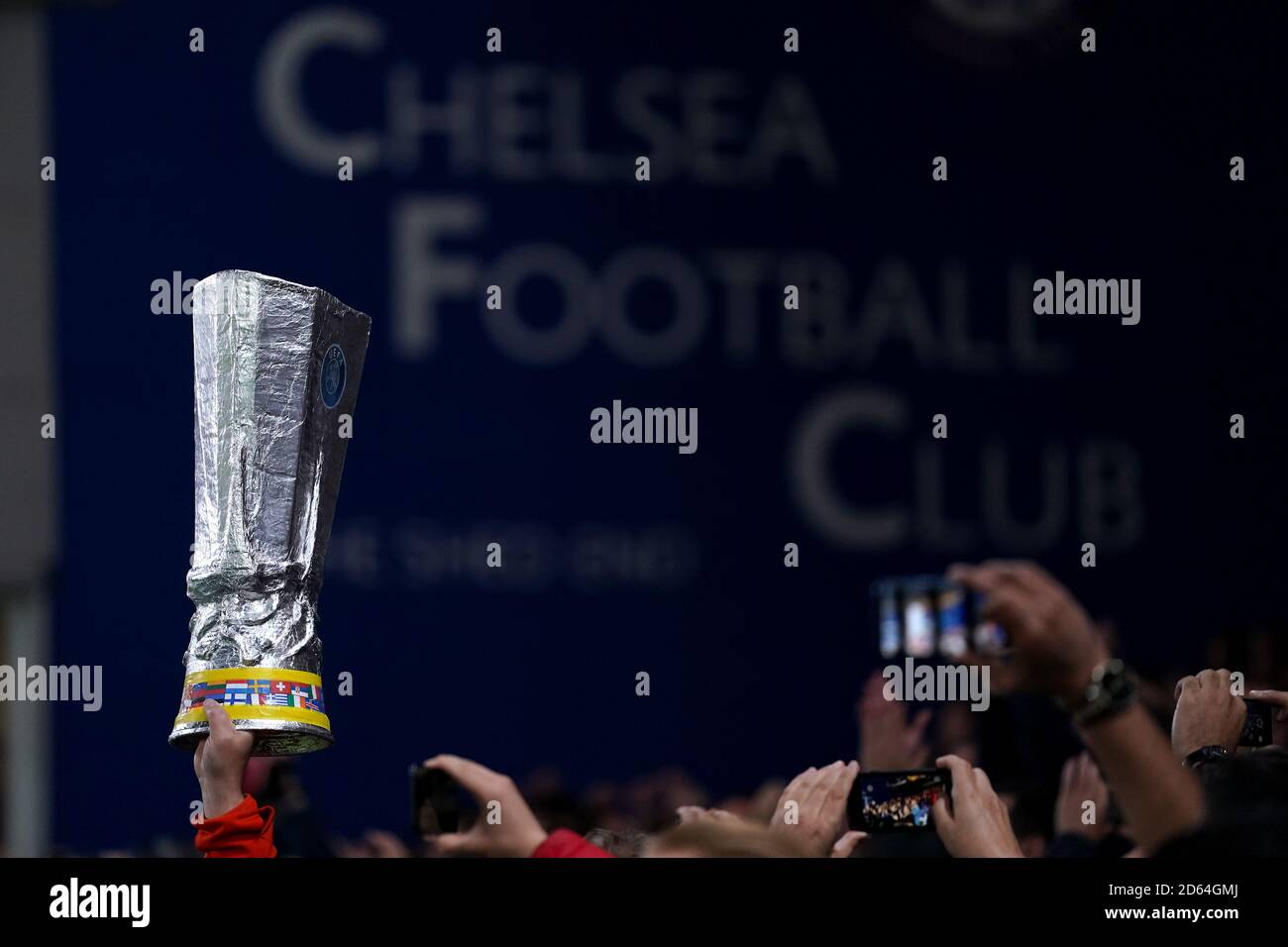Chelsea fans in the stands hold up a replica Europa League trophy Stock Photo