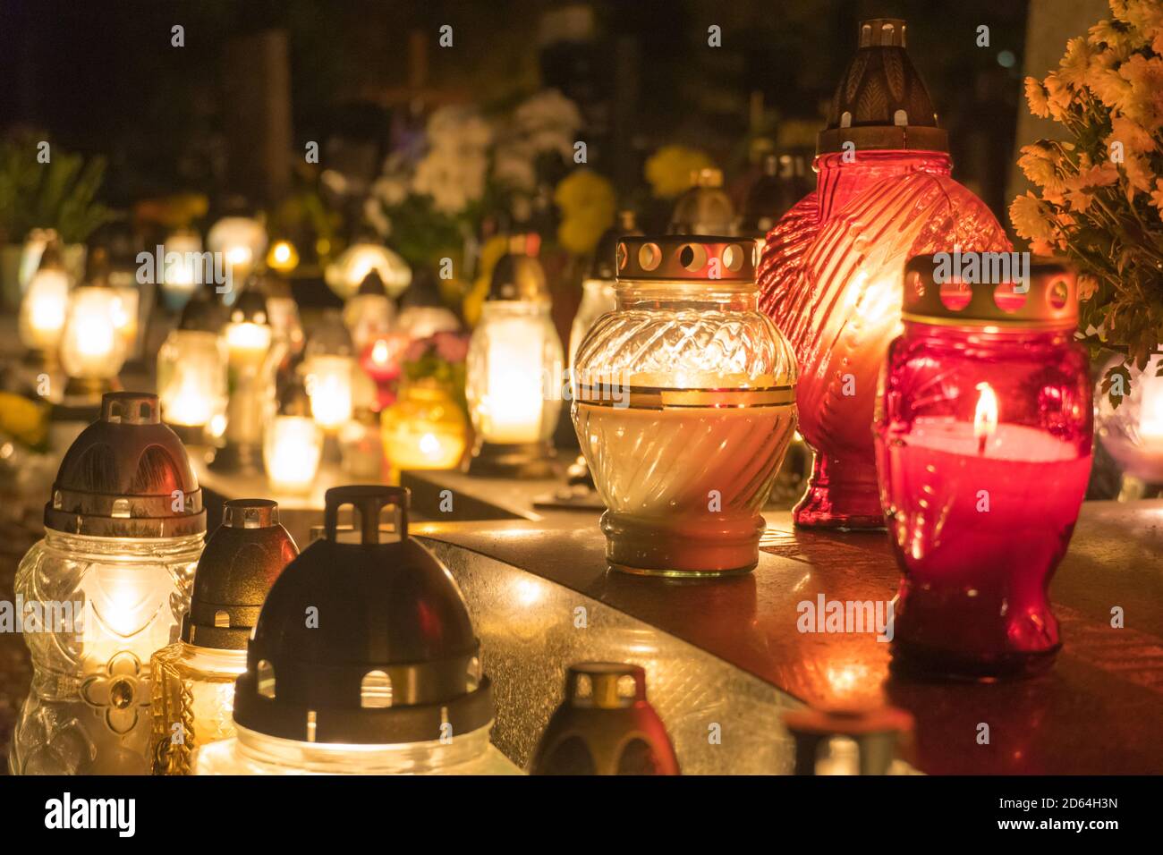 Beautiful background of grave lanterns glowing at night, close up Stock
