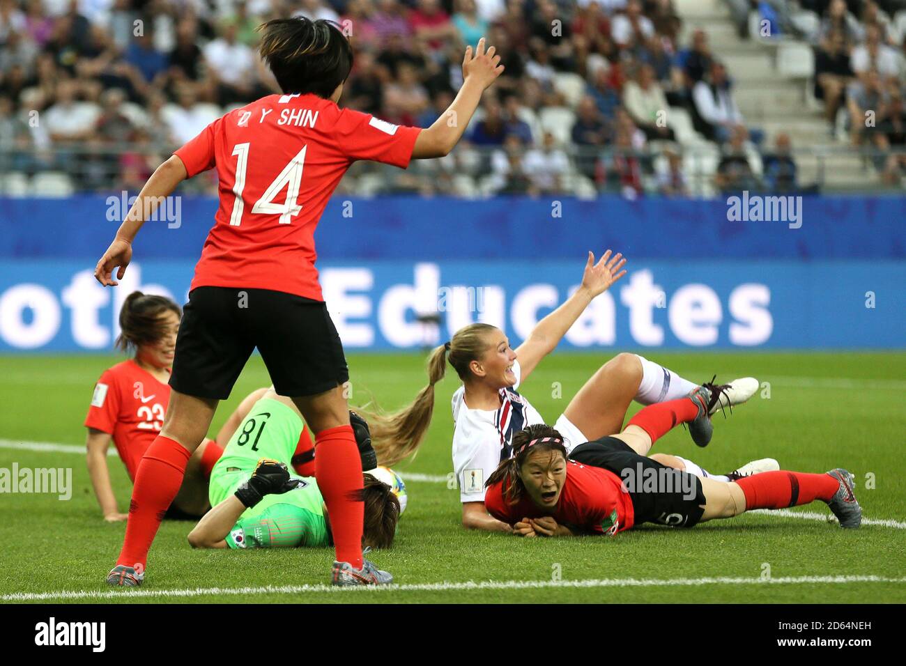 South Korea goalkeeper Kim Minjung (centre) lies injured on the pitch Stock Photo