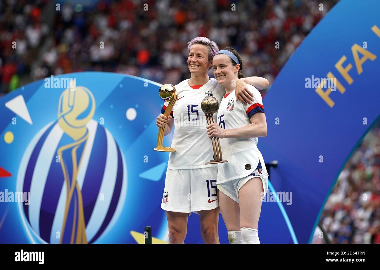 USA's Megan Rapinoe (left) and Rose Lavelle celebrate with their gold and bronze ball trophies respectively after the game. Stock Photo