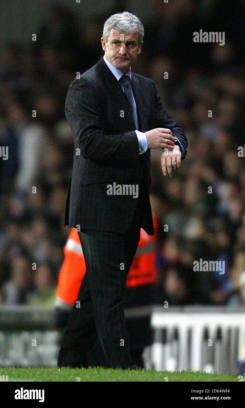 Blackburn Rovers manager Mark Hughes checks his watch Stock Photo