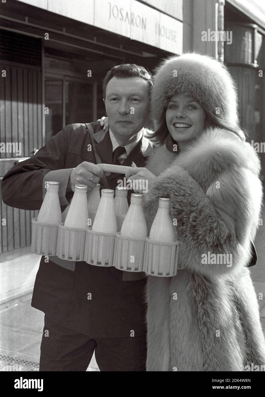 At the National Dairy Centre Peter Lucas, 43, of Dorking, who is employed by Unigate Ltd, is pictured at their Westcott Depot, meets Susan Cuff, Miss Great Britain. Susan was on hand to present him with the prize of Â£500 for winning the title 'Personality Milkman for 1976'. Stock Photo