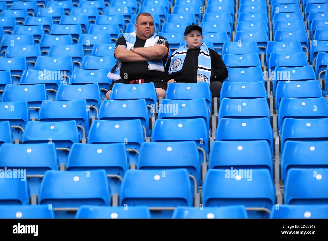 Manchester City fans sit in the stands before kick off Stock Photo