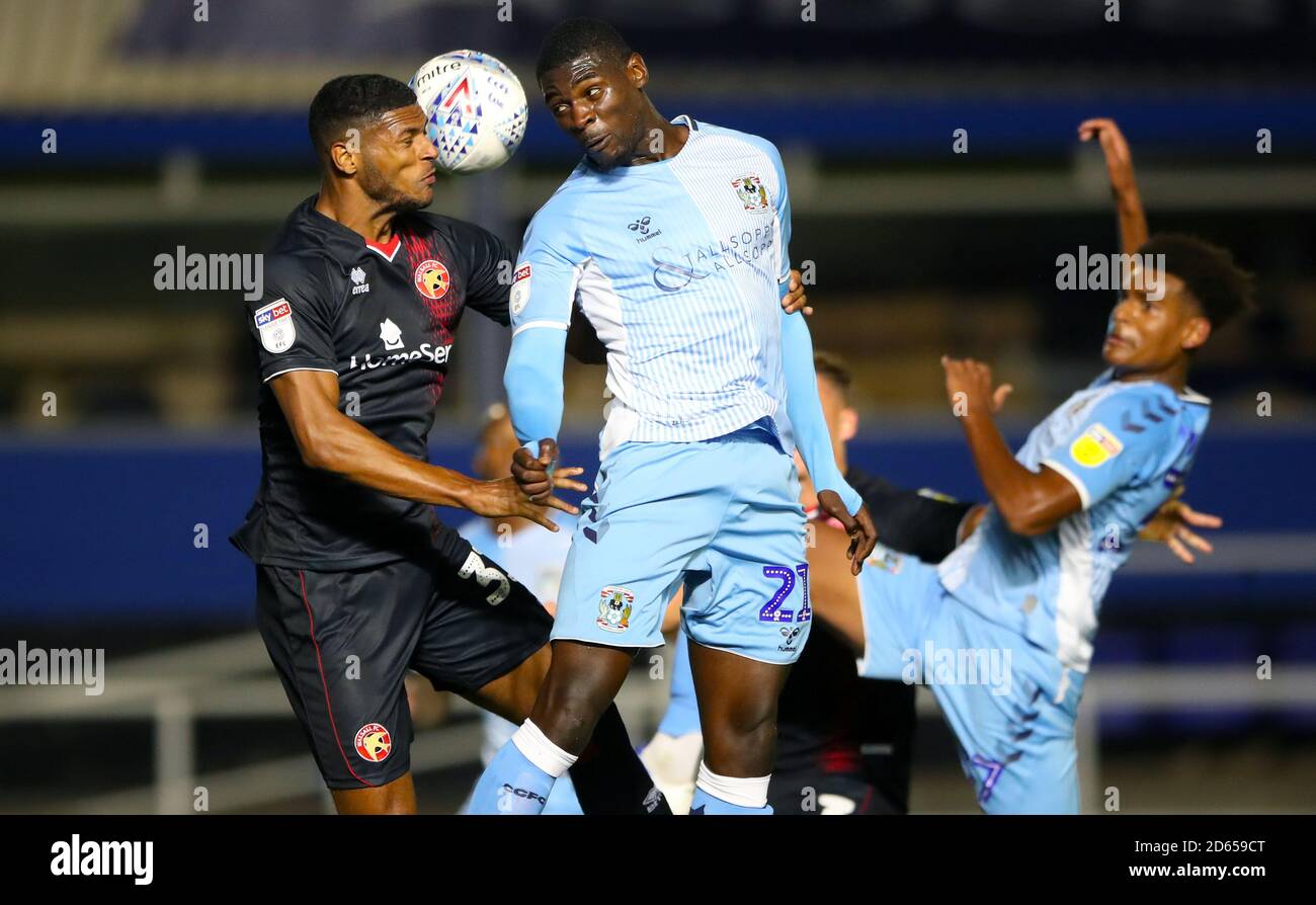Walsall's Zak Jules and Coventry City's Amadou Bakayoko battle for the ball in the air Stock Photo