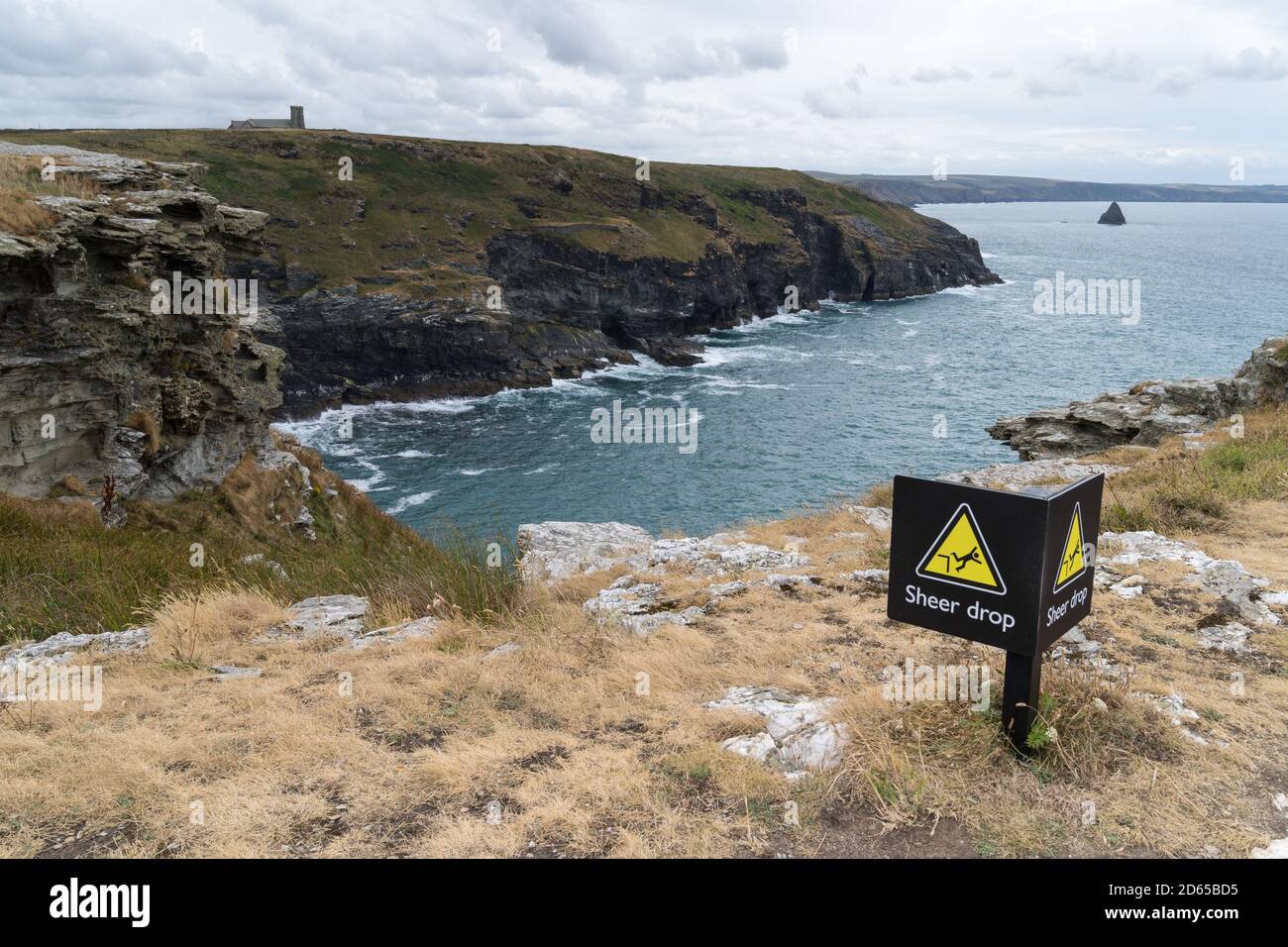 Panorama View from the top of cliffs in Cornwall, England, UK with a sign warning for danger becaise of sheer drop Stock Photo