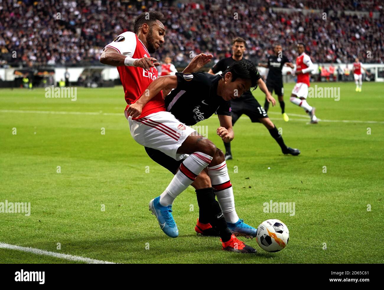 Eintracht Frankfurt's Makoto Hasebe (right) and Arsenal's Pierre-Emerick Aubameyang battle for the ball Stock Photo