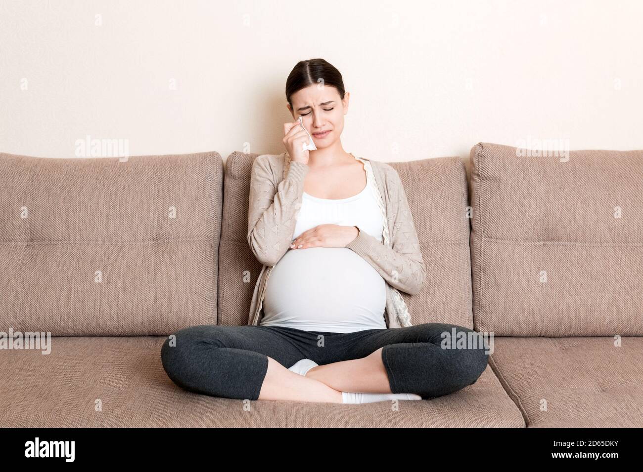 Young pregnant woman crying on sofa at home Stock Photo Alamy