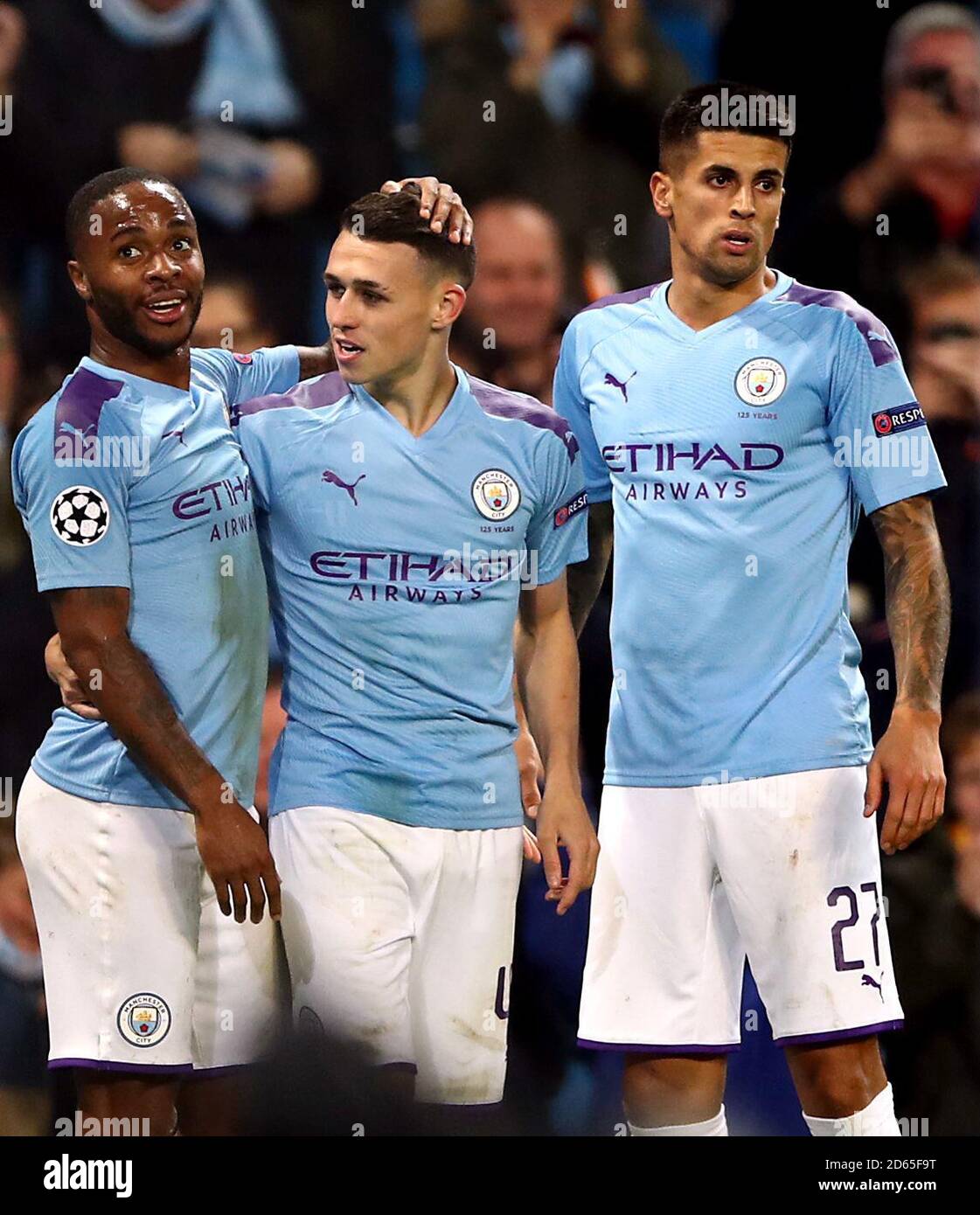 Manchester City's Phil Foden (centre) celebrates scoring his side's second goal of the game with Raheem Sterling (left) and Joao Cancelo (right) Stock Photo