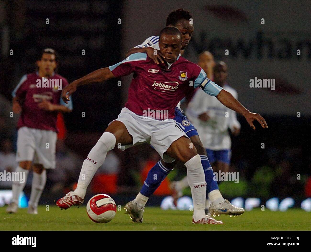 West Ham United's Nigel Reo-Coker (front) and Chelsea's Michael Essien battle for the ball. Stock Photo