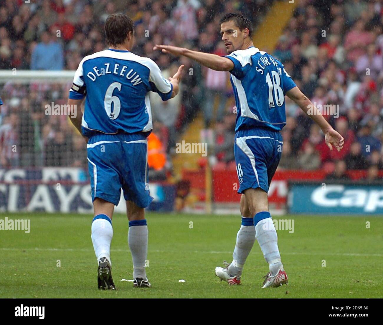 Wigan's Paul Scharner (right) celebrates scoring the first goal of the game, with team captain Arjan De Zeeuw. Stock Photo