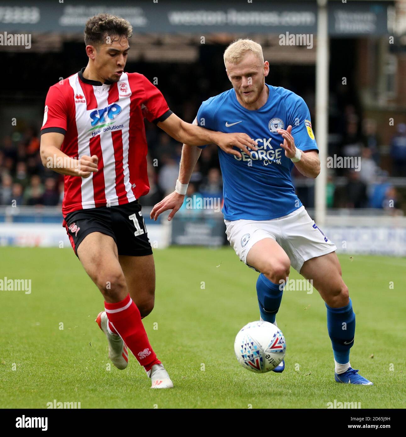 Peterborough United's Frazer Blake-Tracy and Lincoln City's Tyler Walker Stock Photo