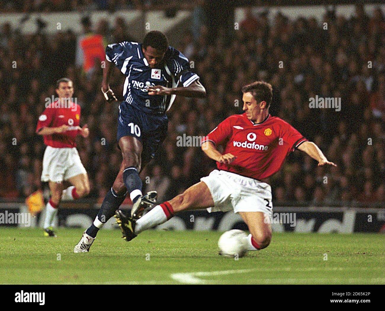 Manchester United's Gary Neville tackles Lille's Dagui Orphie during the  Champions league game at Old Trafford Stock Photo - Alamy