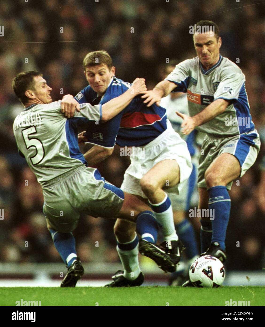 Rangers Tore Andre Flo is held back by Dunfermline Athletic's Andrius Skerla (left) and Ian Ferguson (right). Stock Photo